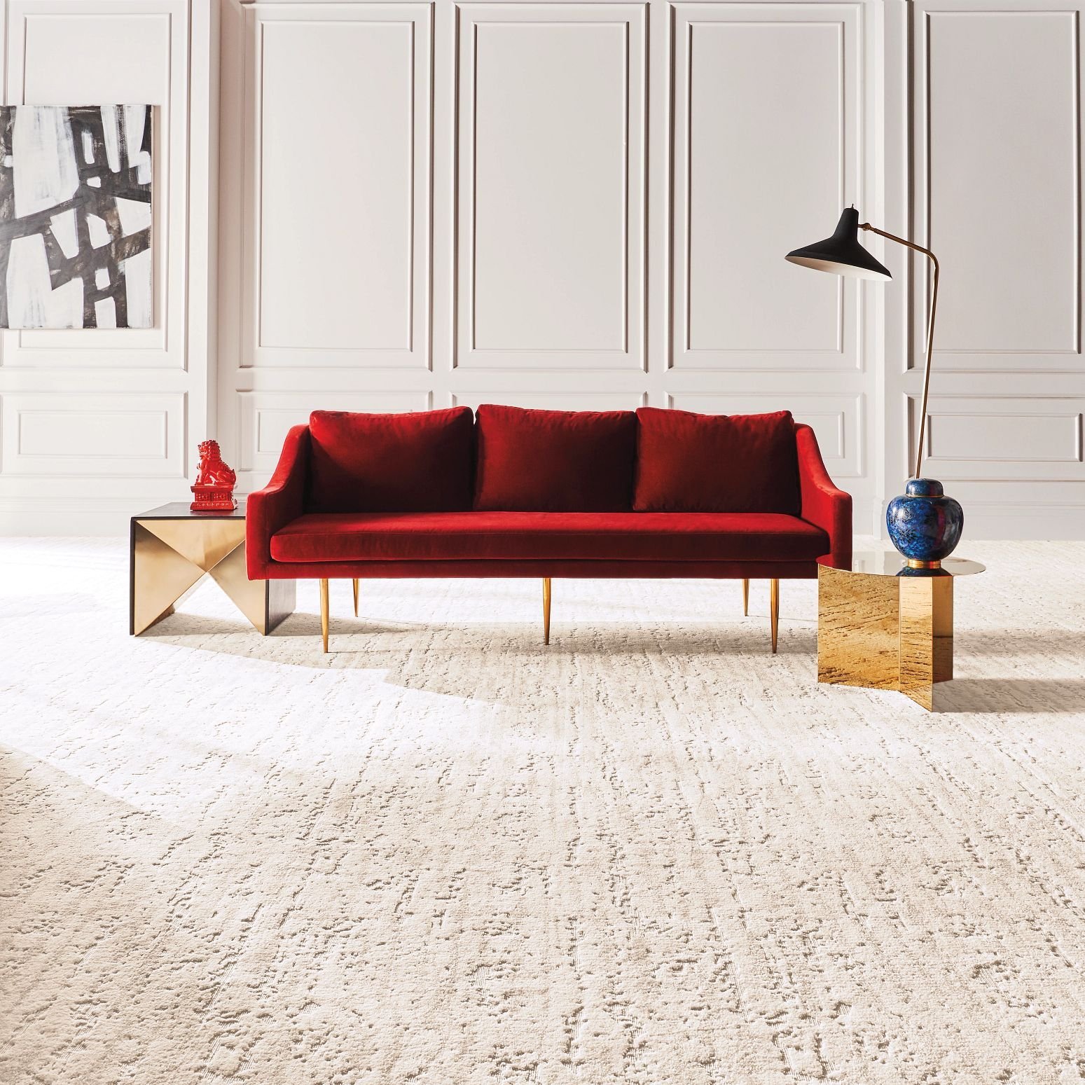 Bright living room with a red velvet couch and beige textured carpet from Carpet Villa in Grand Rapids, MI